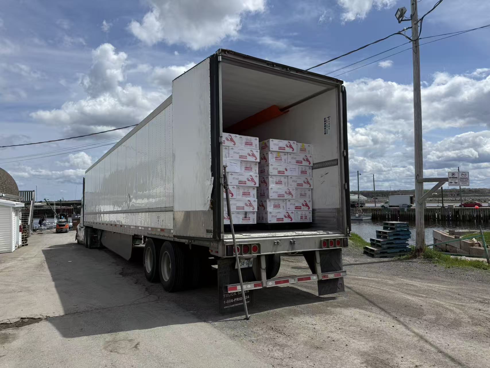 A 2026 shipment of live Canadian lobster being loaded into a refrigerated truck for delivery to China